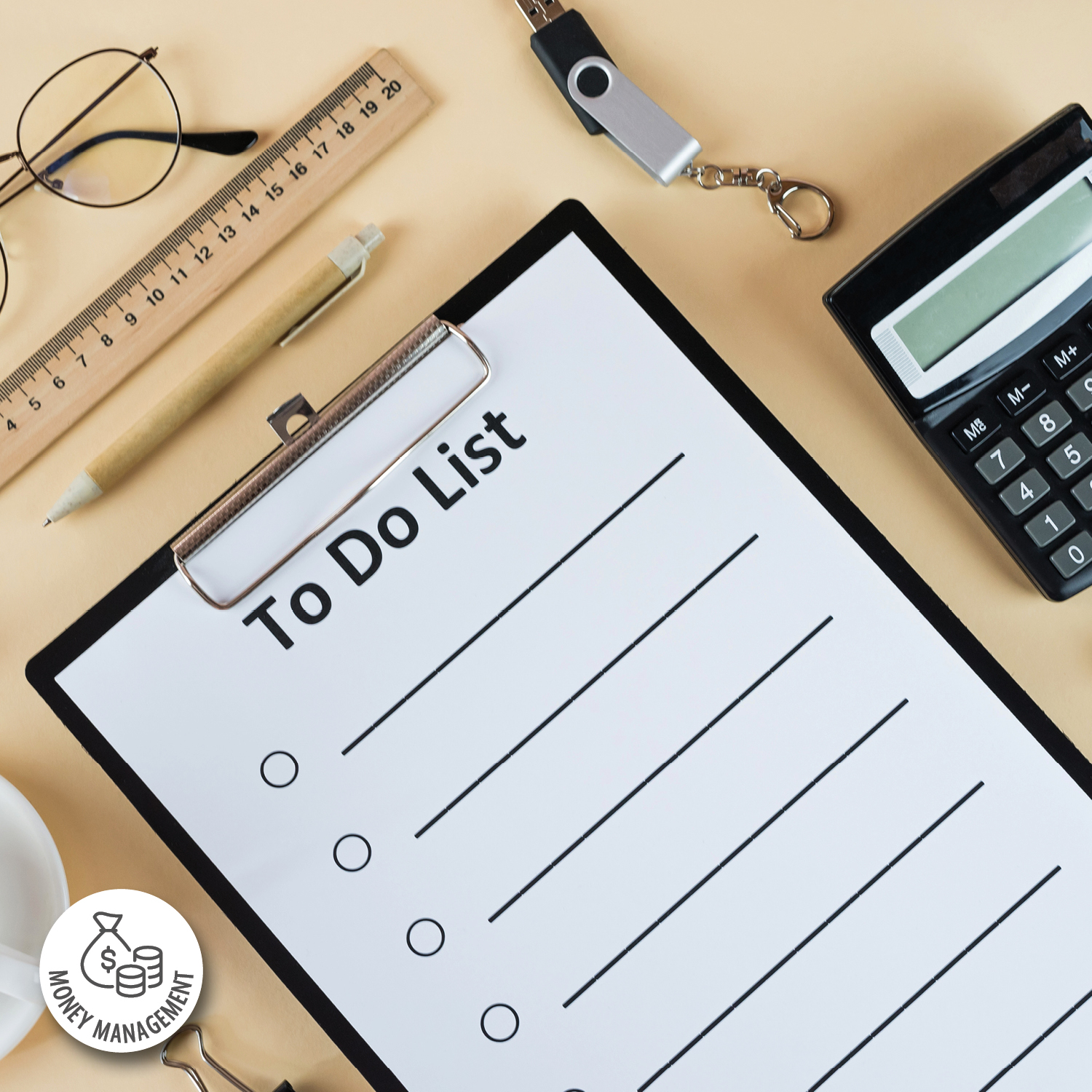 Photograph of a blank to-do list on a clipboard surrounded by office supplies including a ruler, pen, glasses, USB drive, and calculator. The setup suggests organization and planning for money management tasks, with clean lines and neutral tones emphasizing clarity and focus.