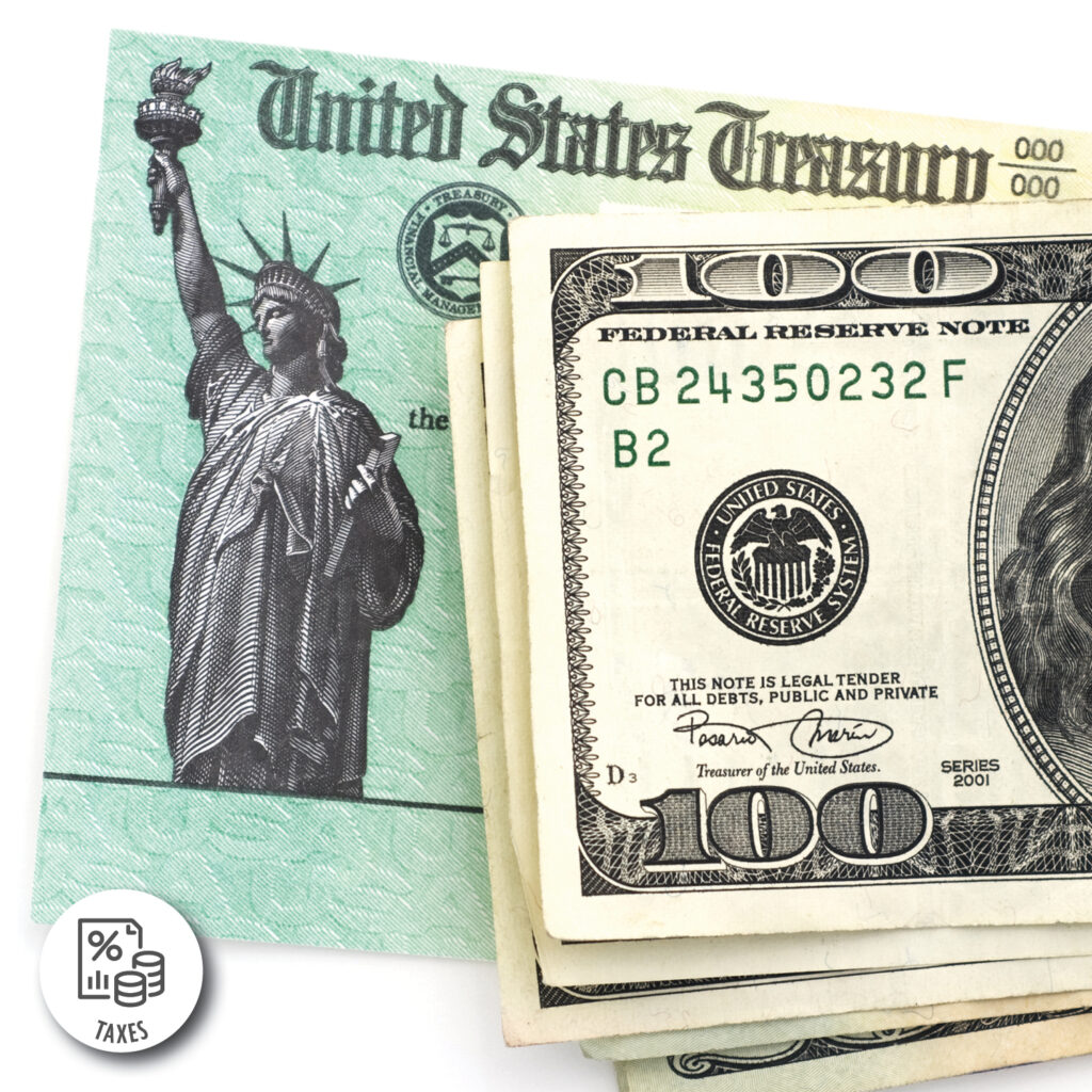 Photograph showing a United States Treasury check partially covered by several 100-dollar bills, highlighting financial transactions or payments. The check features a green background with the Statue of Liberty and Treasury seal, while the bills display serial numbers, Federal Reserve seals, and denomination markings.